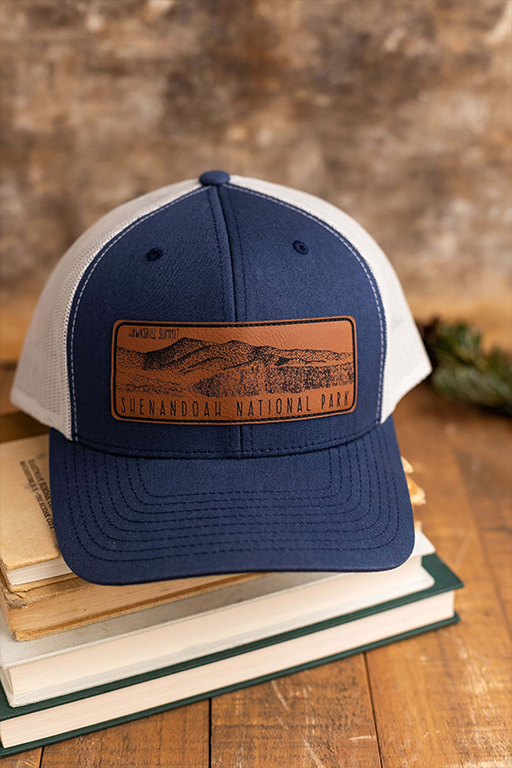 blue and white hat with a tan patch with a picute of mountains and text that says Shenandoah national park